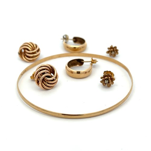 414 - A 9ct gold bangle and 3 pairs of 9ct gold earrings including a flower design pair with diamond accen... 