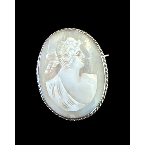 422 - Three shell cameo brooches, one with a 9ct gold mount and two with silver mounts.