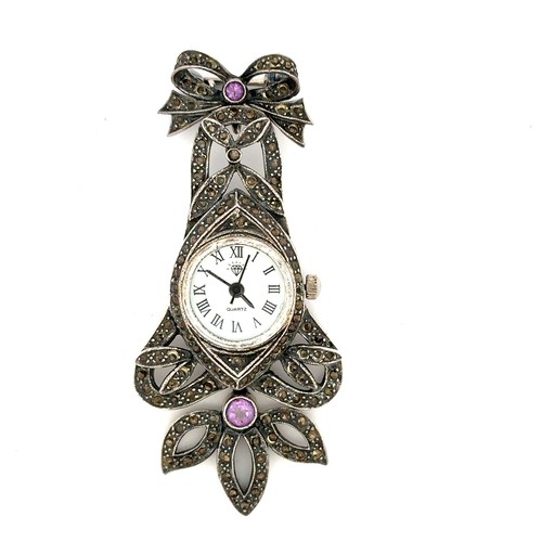 629 - A modern marcasite quartz watch set with two purple gemstones, stamped 925. Length 67mm approx. Watc... 