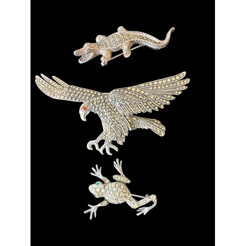 413 - Three brooches in the form of different animals: a 9cm long marcasite eagle brooch with an orange ge... 