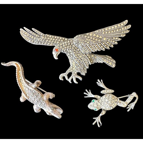 413 - Three brooches in the form of different animals: a 9cm long marcasite eagle brooch with an orange ge... 