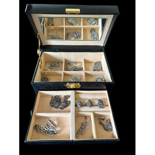 486 - A jewellery box containing a number of silver and white metal  jewellery items, some set with marcas... 