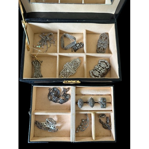 486 - A jewellery box containing a number of silver and white metal  jewellery items, some set with marcas... 