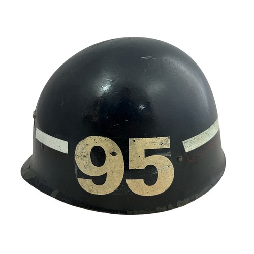 205 - A Military Police helmet by Steinberg Bros, American, with liner and chin strap.