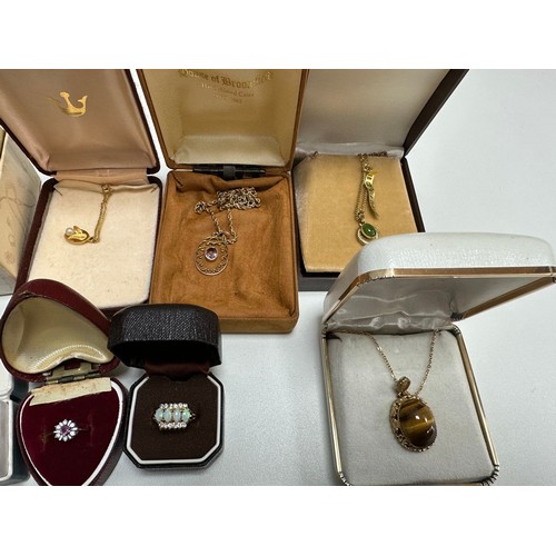 504 - A selection of jewellery including an amethyst pendant stamped 9ct, two 18ct gold plated gemset neck... 