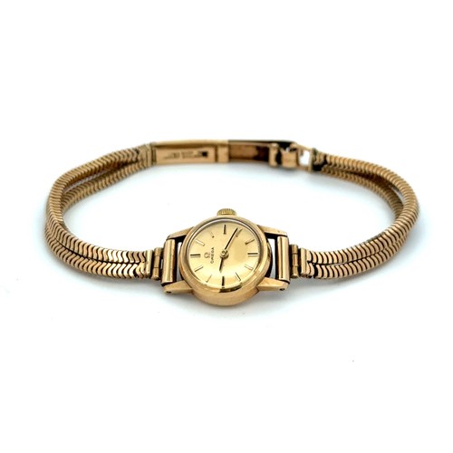 558 - Omega 9ct gold ladies wristwatch and bracelet, in branded box of issue with booklet/certificate date... 