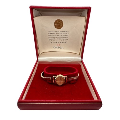 558 - Omega 9ct gold ladies wristwatch and bracelet, in branded box of issue with booklet/certificate date... 