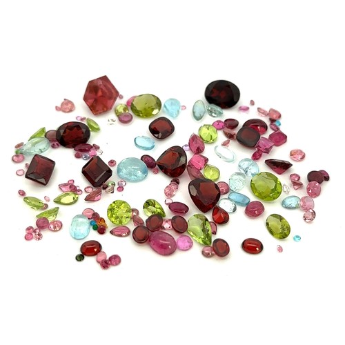 527 - Some loose unmounted vari-shaped peridot, garnet, aquamarine and tourmaline gemstones.