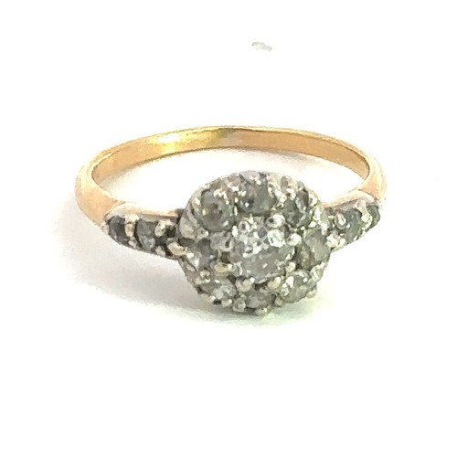 463 - A gold and old cut diamond cluster ring, stamped 18. Central diamond approx 0.25ct surrounded by 8 f... 