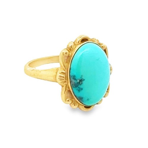 423 - An oval turquoise ring, stamped 10K. Size J. Weight 2.8g approx.