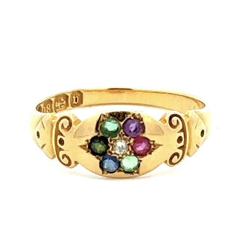 445 - An 18ct gold multi gemstone ring with scroll shoulders, set with diamond, emerald, sapphire, ruby, a... 