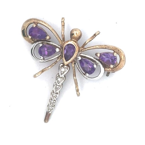 450 - A dragonfly brooch set with amethysts and diamonds. Unmarked metal but tests as 9ct gold. Weight 2.6... 