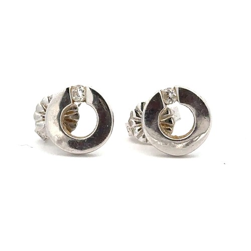 506 - A pair of 18ct white gold and diamond earrings. weight 2g approx