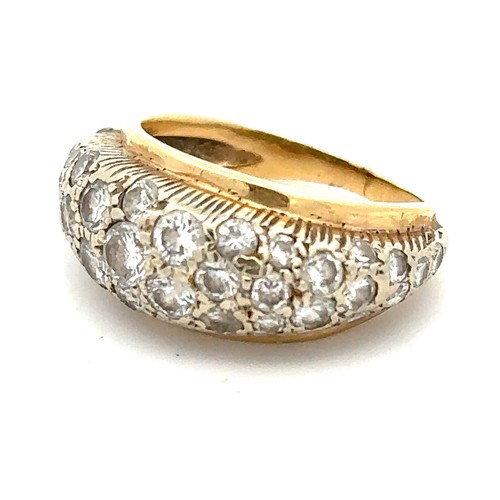 445A - A gold ring set pave with diamonds, the largest of which is approx 02ct and has tiny chip on edge of... 