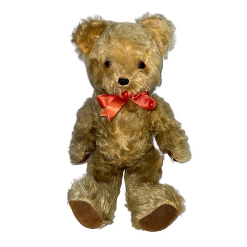 249 - A Pedigree musical teddy bear, with orange and black eyes, jointed arms and legs and red bow. Music ... 