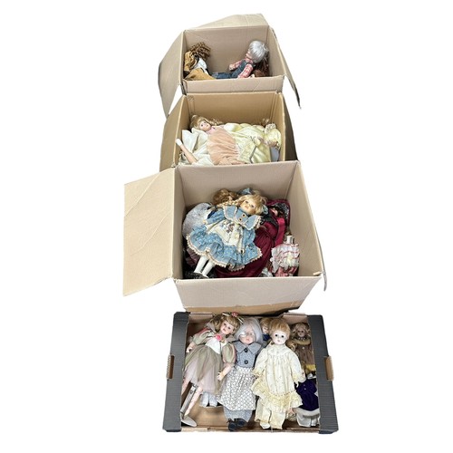 243 - Modern issue unboxed collection of mostly porcelain dolls by Leonardo, many on stands, generally goo... 