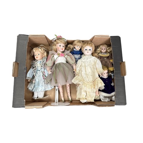 243 - Modern issue unboxed collection of mostly porcelain dolls by Leonardo, many on stands, generally goo... 