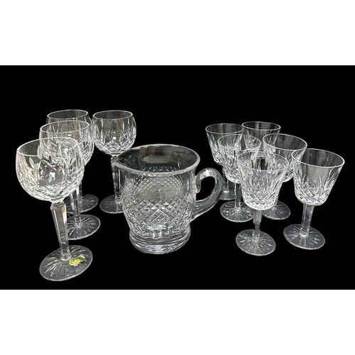 312 - A Waterford Crystal water jug in the Colleen design, height 14.8cm and 10 Lismore design glasses. Th... 