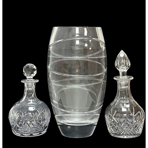 392 - Two glass decanters, one approx 29cm in height, the other 24.5cm in height. And a large glass vase, ... 