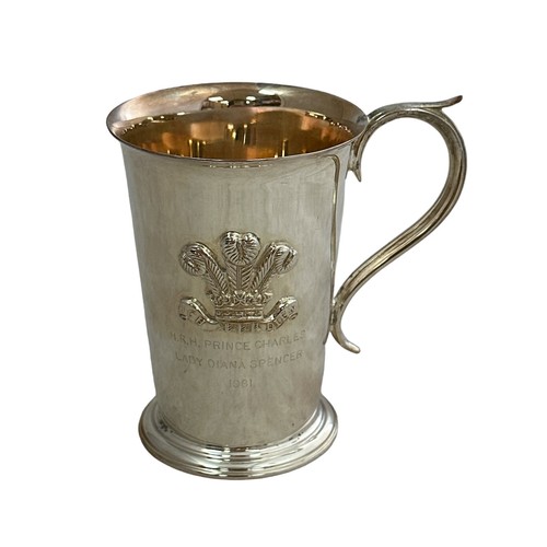 188 - A Barker Ellis tankard with scroll handle. Commemorating the marriage of Charles and Diana and embos... 