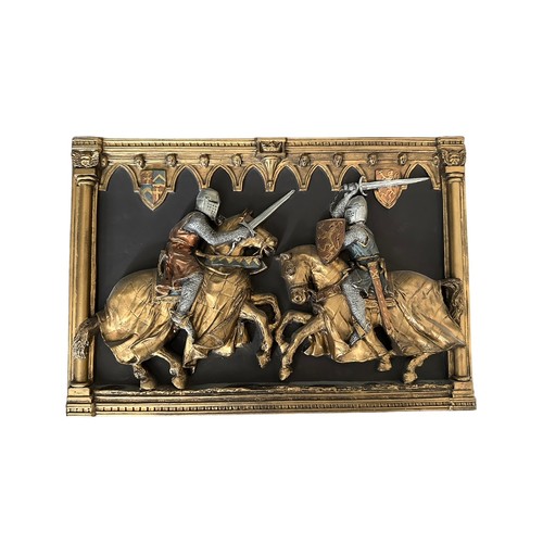 340 - A pair of Marcus Designs hall plaques of jousting/fighting knights, both 22cm by 32cm.