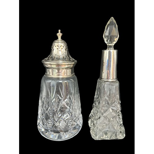 209 - A Barker Ellis  cut glass sugar shaker with silver mount. 1979 Hallmarks. Weight 354g. Also a glass ... 