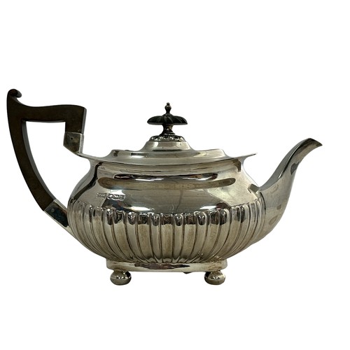 201 - A silver teapot by Walker & Hall with a rectangular body with half fluted design, four ball feet, an... 