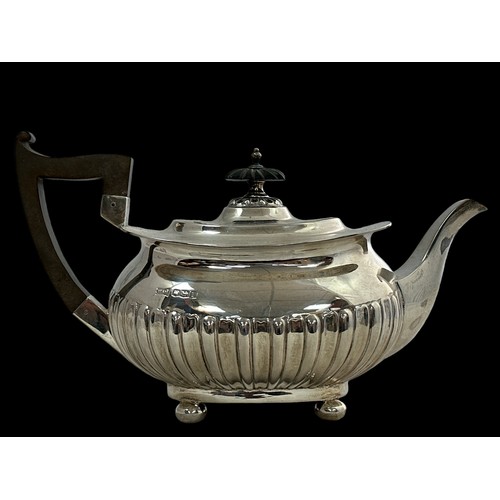 201 - A silver teapot by Walker & Hall with a rectangular body with half fluted design, four ball feet, an... 