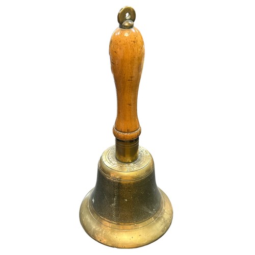 121 - An Air Raid Precautions (ARP) brass hand bell with wooden handle. Marked J.B. and 39.