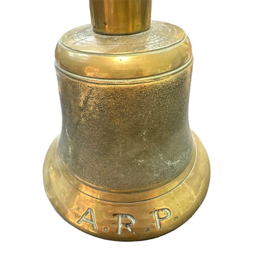 121 - An Air Raid Precautions (ARP) brass hand bell with wooden handle. Marked J.B. and 39.