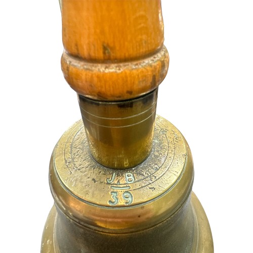 121 - An Air Raid Precautions (ARP) brass hand bell with wooden handle. Marked J.B. and 39.