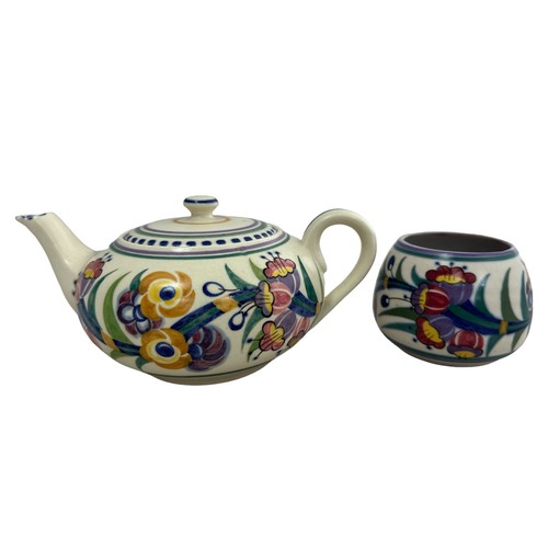 406 - A Poole Pottery teapot and sugar bowl. In good condition.