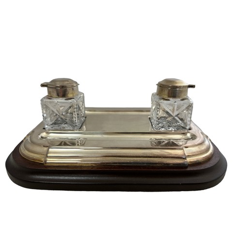 292 - A Barker Ellis desk inkwell with wooden base and two glass bottles with white metal mounts.