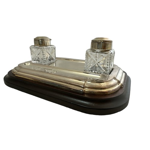 292 - A Barker Ellis desk inkwell with wooden base and two glass bottles with white metal mounts.