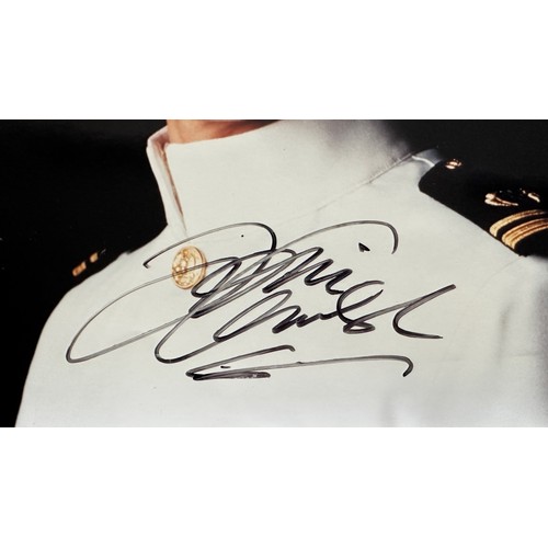 267 - Tom Cruise (b. 1962) – Top Gun, unframed signed colour photograph of Tom Cruise in white pilot unifo... 