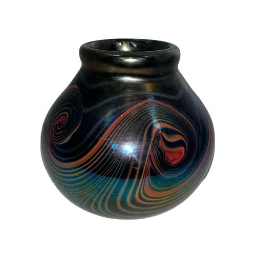 126 - John Ditchfield (British, 1952-) a iridescent purple studio glass vase with swirling pattern signed ... 