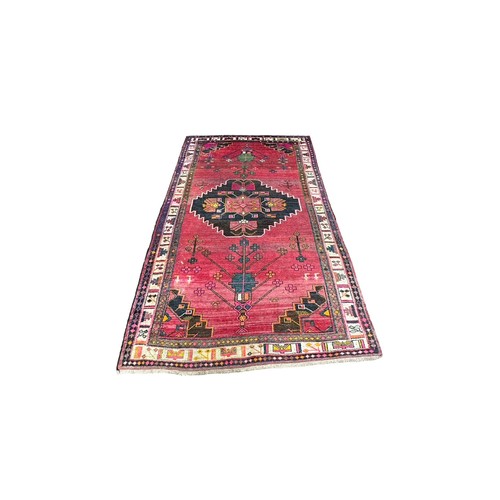 47 - Large Eastern (possibly Turkish) woven ground rug, stylised floral and geometric pattern with red ba... 