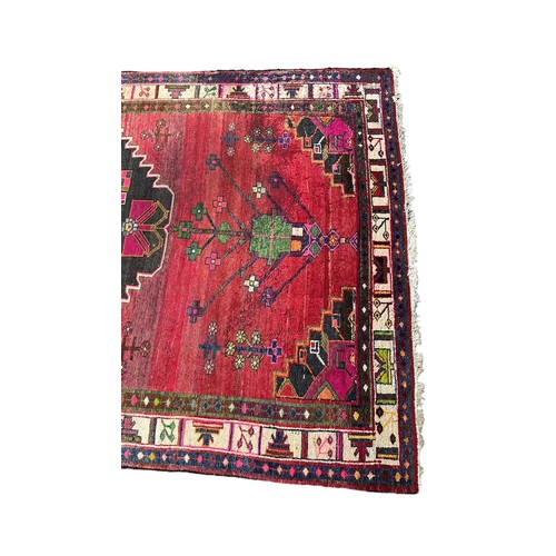 47 - Large Eastern (possibly Turkish) woven ground rug, stylised floral and geometric pattern with red ba... 