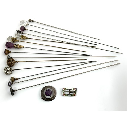 336 - A number of paste and white metal hat pins and two sterling silver brooches.