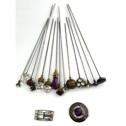 336 - A number of paste and white metal hat pins and two sterling silver brooches.