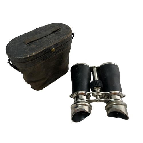 105 - A pair of binoculars in a leather case, marked '6 lenses'.