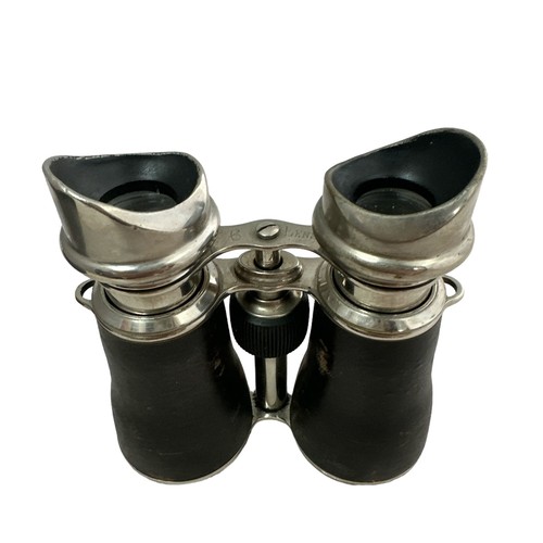 105 - A pair of binoculars in a leather case, marked '6 lenses'.