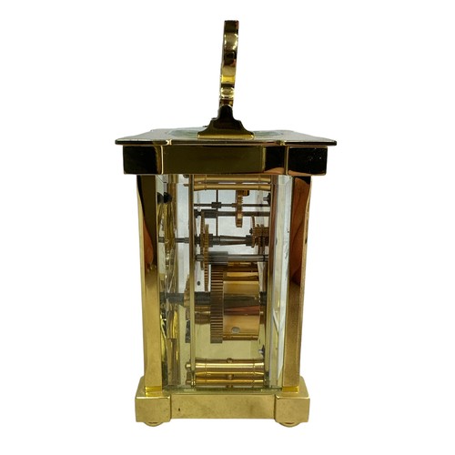 132 - A brass cased carriage clock with bevelled glass panels, Matthew Norman, Swiss Made, complete with k... 