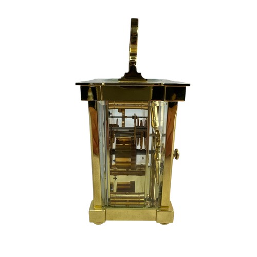 132 - A brass cased carriage clock with bevelled glass panels, Matthew Norman, Swiss Made, complete with k... 