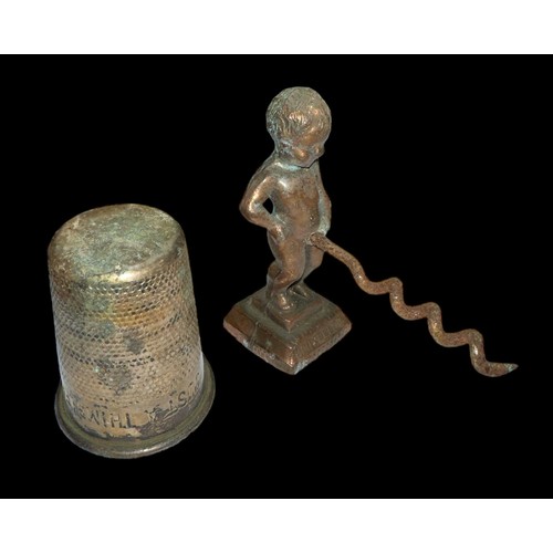 278 - A vintage Manneken Pis corkscrew, rusty. Plus, a Just a Thimbleful shot glass. (2)