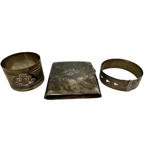 217 - A silver cigarette case (dented and tarnished) and an adjustable silver bangle. Also a trench art Yp... 