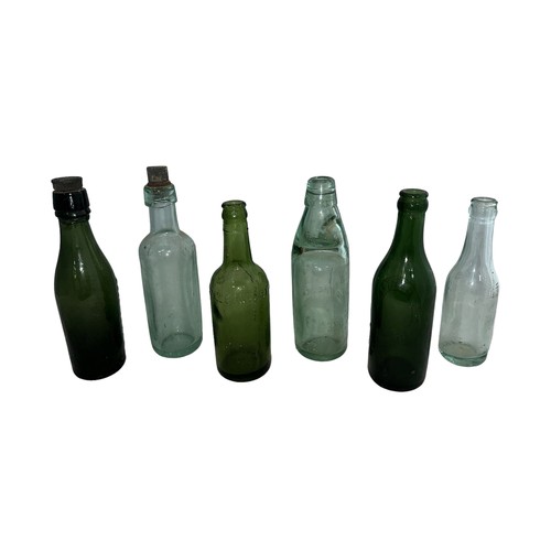 115 - Selection of six various glass bottles to include; a Wood Brothers Daventry Codd Bottle with marble,... 