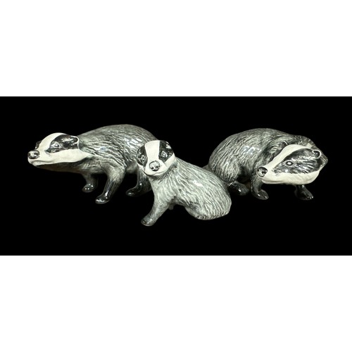 14 - Beswick, a group of three Badger figurines, to include; two seated badgers (facing opposite directio... 