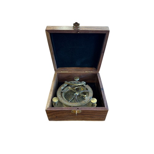 107 - Nautical West brass compass sundial in wooden box.