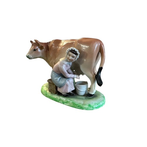 420 - Ceramic milk maid milking cow figure (likely Staffordshire). Height 11.5cm, length 14cm.